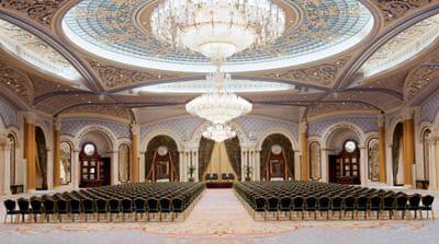 Vast ballroom set up for a business function with theater-style seating