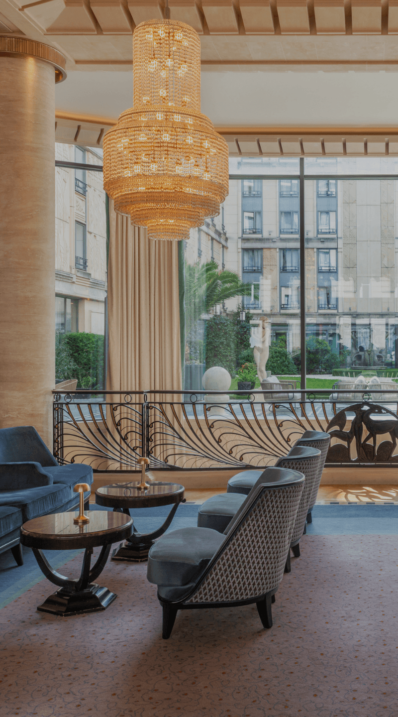Elegant lounge with a grand piano, the refined ambiance of the Hotel du Collectoreur.