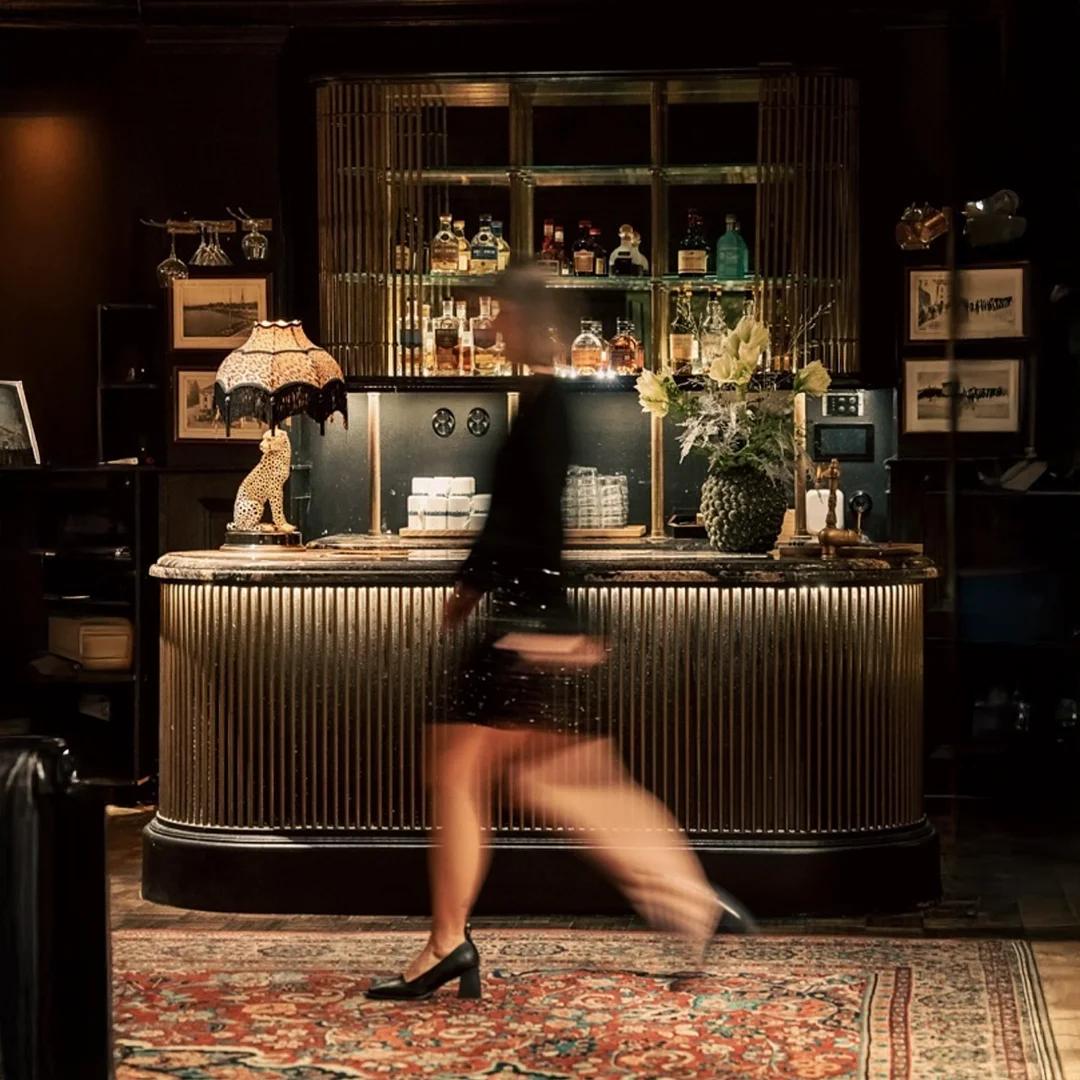 Gäst passerar eleganta cocktailbaren på Ystad Saltsjöbad.