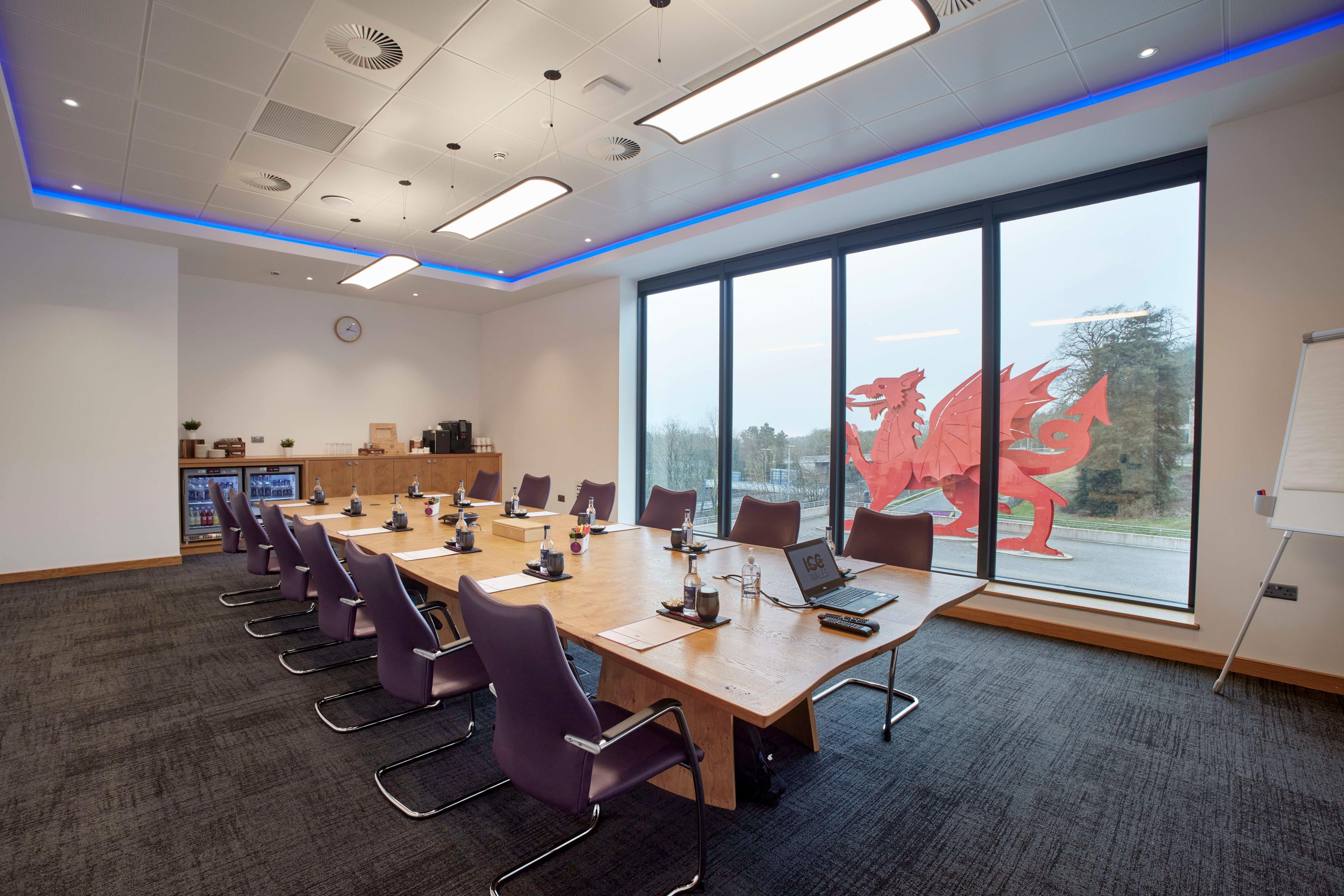 A meeting room at ICC Wales, with purple chairs around a rectangular table