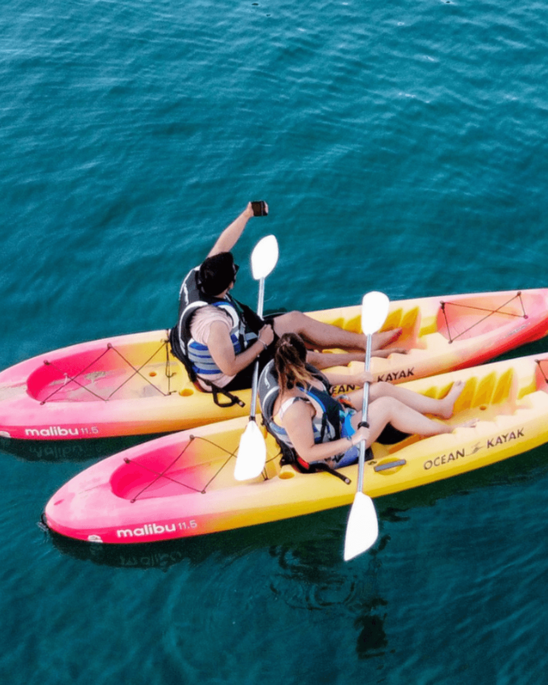 a couple of people in kayaks on the water