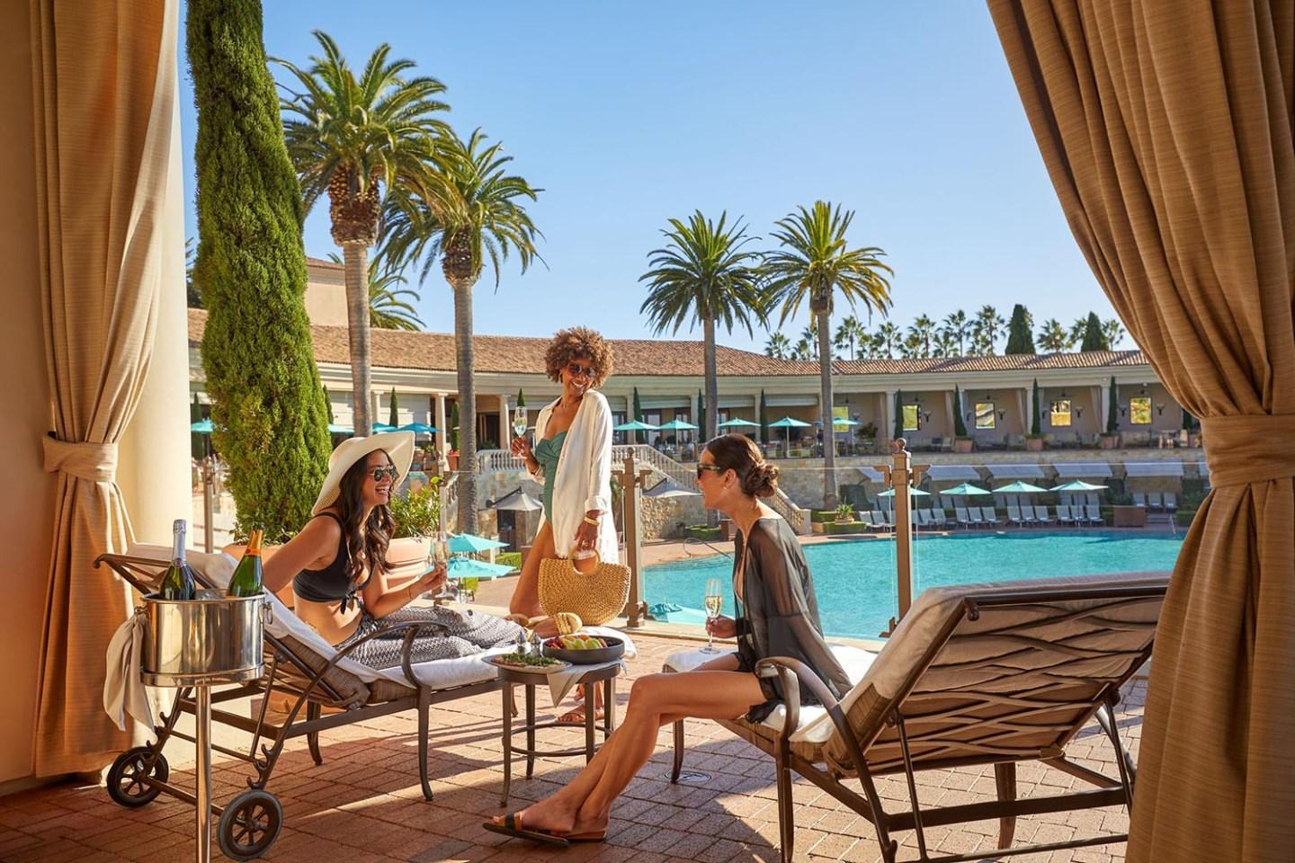 women at the coliseum pool cabana