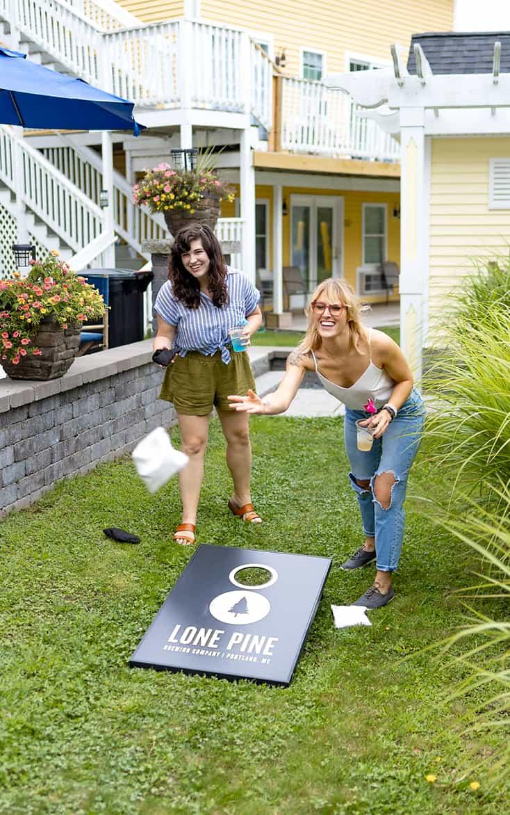 Two women playing corn hole near our Ogunquit vacation rental