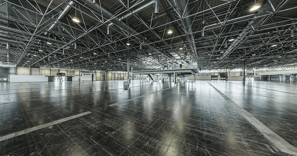 Interior view of the empty Hall B at VIECON - Vienna Congress & Convention Center, showing a wide, open event space with high ceilings and a flexible floor plan.