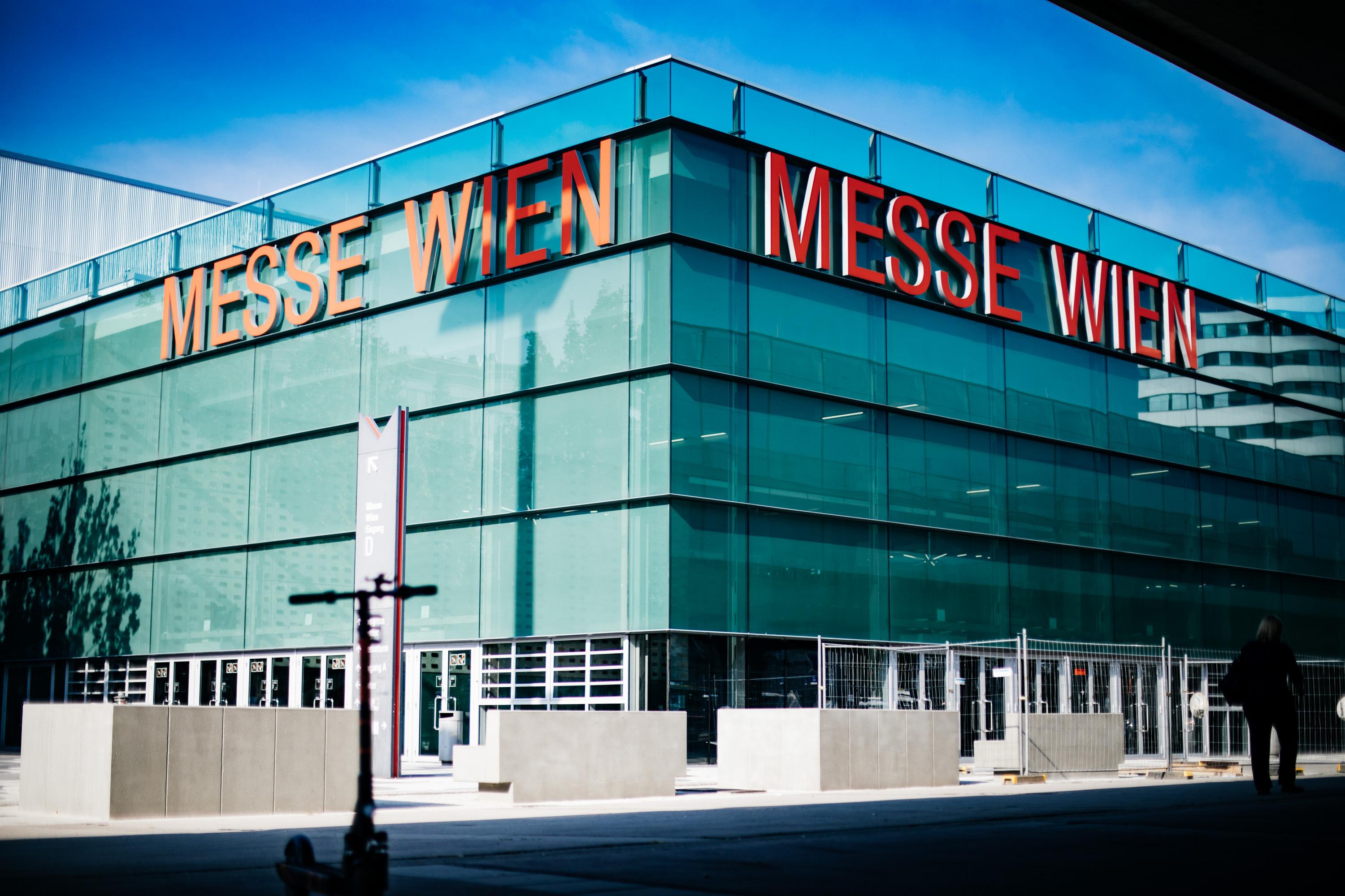Exterior view of Foyer D at VIECON - Vienna Congress & Convention Center, showing the glass façade and prominent entrance signage.