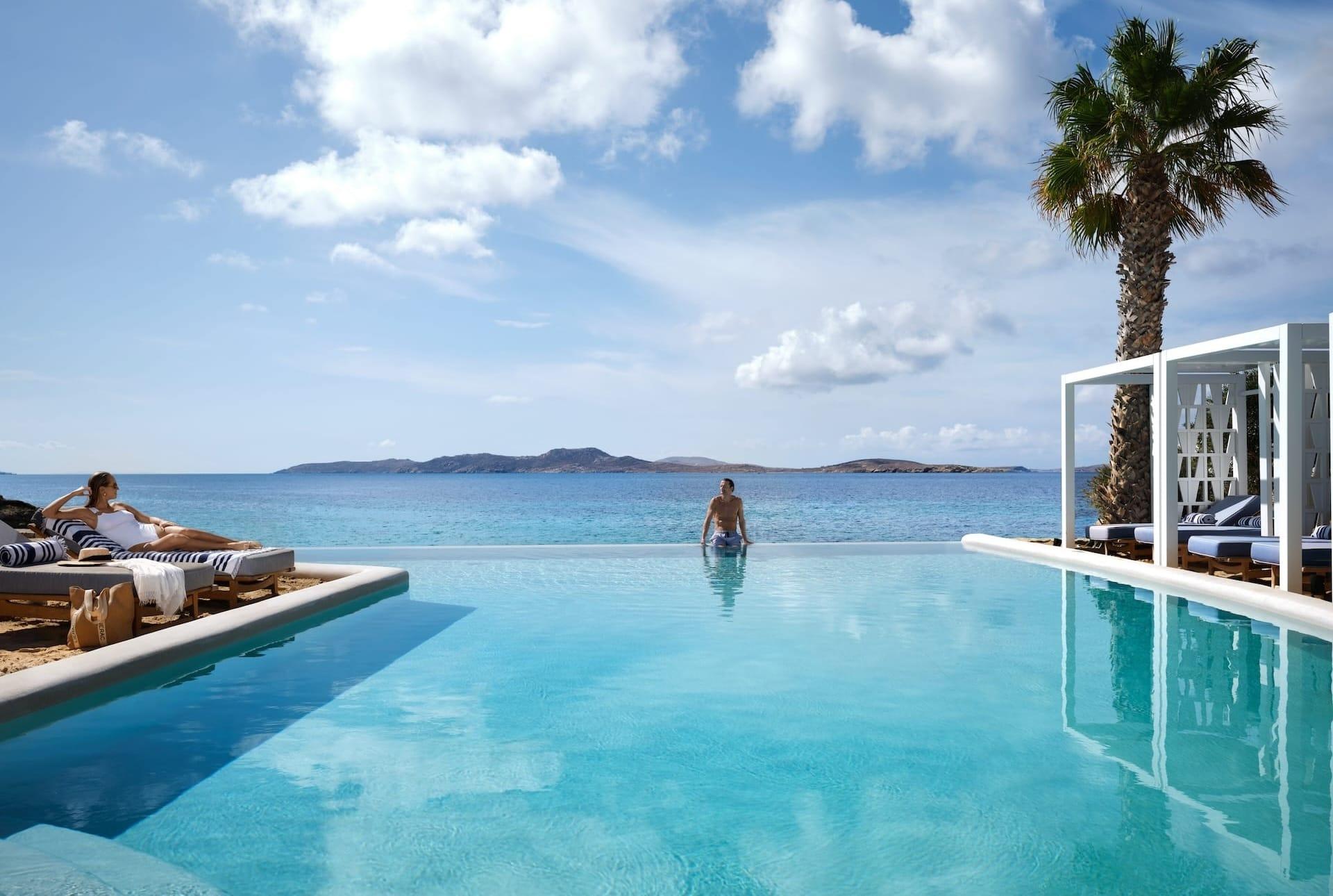 The crystal clear infinity pool of Mykonos Grand overlooking the amazing sea view.